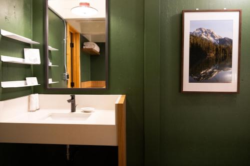 a bathroom with a sink and a mirror at The Hostel in Teton Village