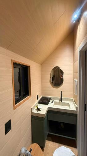 a small bathroom with a sink and a mirror at Hotel Terra do Sal in Mossoró