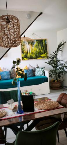 a living room with a table and a couch at L'Obernai in Obernai