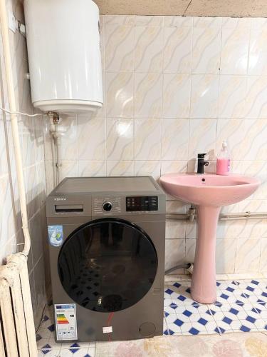 a washing machine in a bathroom with a sink at NURDAN Guest House Barskoon in Barskoon