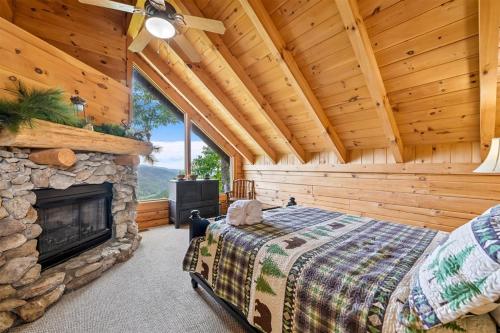 a bedroom with a fireplace in a log cabin at Above It All #38 by Venture Smoky Mountains in Sevierville