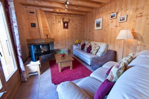 a living room with a couch and a fireplace at Riders Refuge - Chalet Eterle in Morzine