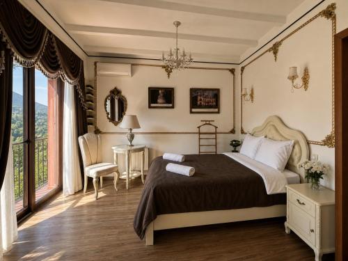 a bedroom with a bed and a large window at Pesvebi Design Hotel and Cellar in Borjomi