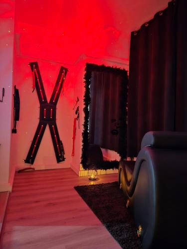 a red room with a couch and a mirror at Love Room Owfeah in Pointe-à-Pitre