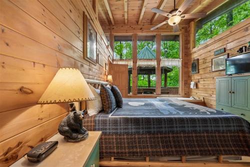 a bedroom with a bed in a log cabin at Amazing Grace #25 by Venture Smoky Mountains in Sevierville