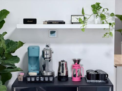 a table with a coffee maker and a blender on it at Tropical Luxe Villa-Near Airport, Minutes to Lido key beach, Downtown and Dining in Sarasota