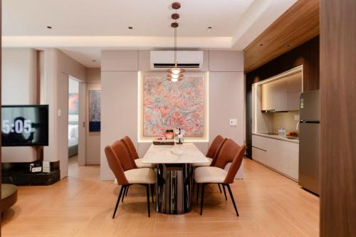 a kitchen and dining room with a table and chairs at The Pathway Sầm Sơn in Sầm Sơn