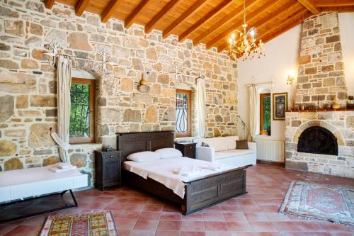 a bedroom with a bed and a stone wall at Villa Mandarin by Important Group Travel in Bitez