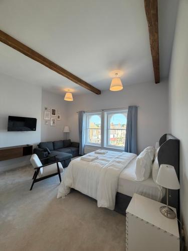 a bedroom with a large bed and a living room at Nova Rooms in Thirsk