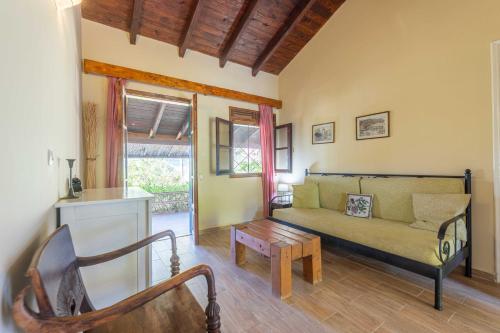 a living room with a couch and a table at Zanteva-Cottages in Vasilikos