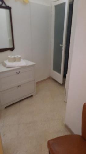 a bathroom with a sink and a mirror and a dresser at Il fortino affittacamere in Porto Santo Stefano