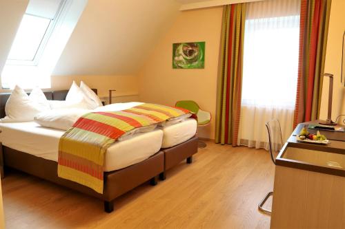 a bedroom with a bed and a desk and a window at Sorgerhof in Frauental an der Lassnitz 