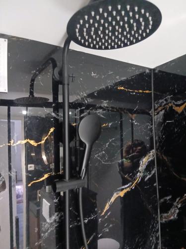 a ceiling light in a room with black marble at Urban Maghin in Liège