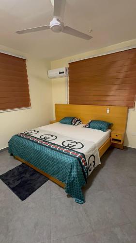 a bedroom with a large bed with a wooden headboard at Affar homes in Kumasi