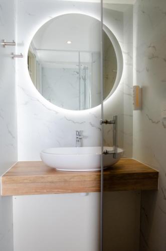 a bathroom with a sink and a mirror at Contact Hôtel Fontenay le Comte in Fontenay-le-Comte