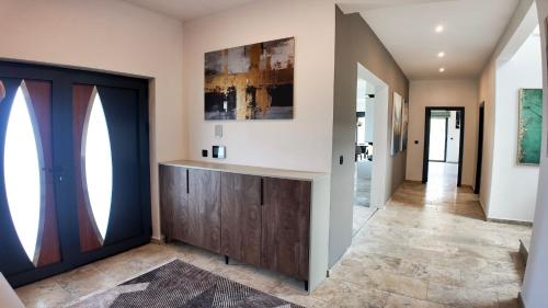 a hallway of a home with a large door at Villa Adria Heights in Pečurice