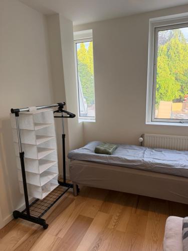 a small bedroom with a bed and a window at 24 h chek in big house in Copenhagen