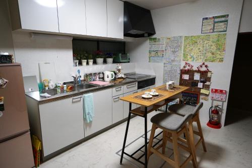 a small kitchen with a table and a counter at Villa Kyoto Saiin in Kyoto