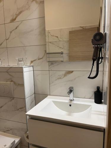 a bathroom with a sink and a camera at Hotel Park Drniš in Drniš