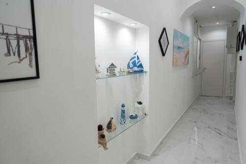 a hallway with white walls and white marble floors at Sogno Di Mezzanotte in Taranto