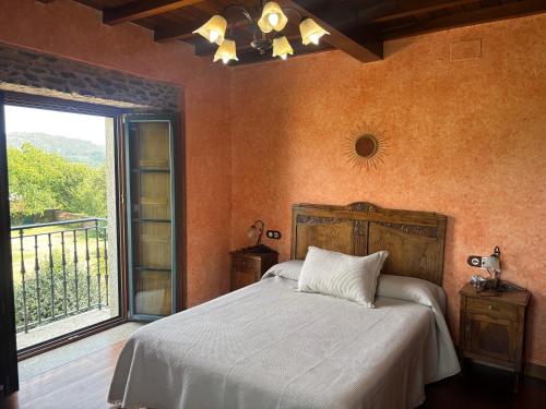 a bedroom with a bed and a large window at Casa Bama in Bama