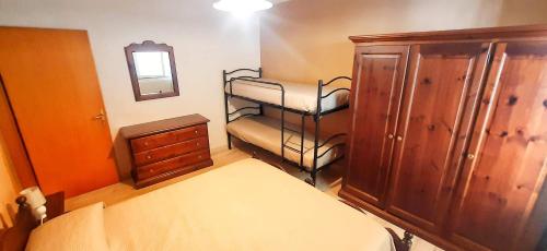 a bedroom with a bed and a dresser and a mirror at Casa di Giò in Capracotta