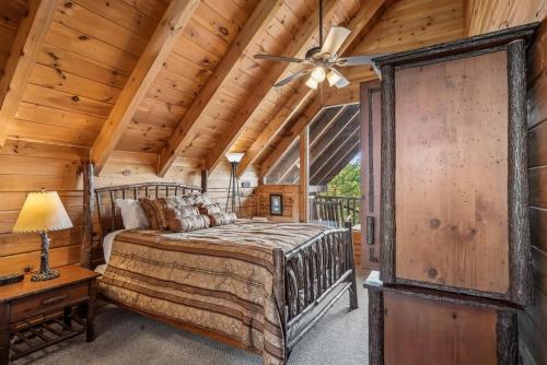 a bedroom with a bed and a ceiling fan at Fox Ridge #37 by Venture Smoky Mountains in Sevierville