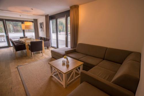 a living room with a couch and a table at Appart Gastauer in Sankt Gallenkirch