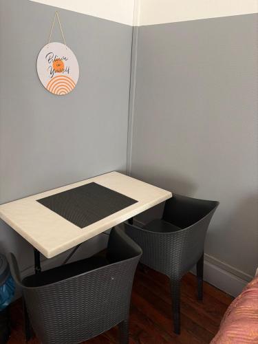 a table and chairs in a room with a table and a table and chairs at Gengoult 3 in Toul
