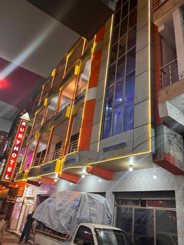 a building with a car parked in front of it at Ruby Bahrain Hotel in Mingāora