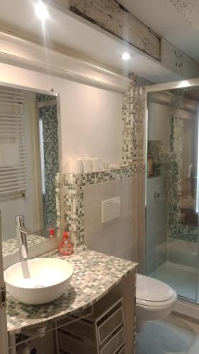 a bathroom with a sink and a toilet and a shower at San Giorgio degli Schiavoni in Venice
