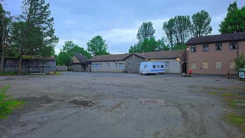 a house with a van parked in front of a driveway at The Garve Flats in Garve