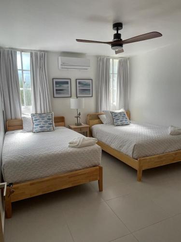 a bedroom with two beds and a ceiling fan at Condo in Puerto Plata in San Felipe de Puerto Plata
