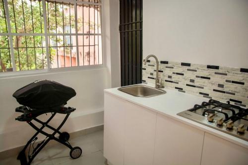 a kitchen with a stroller next to a sink at Condo in Puerto Plata in San Felipe de Puerto Plata