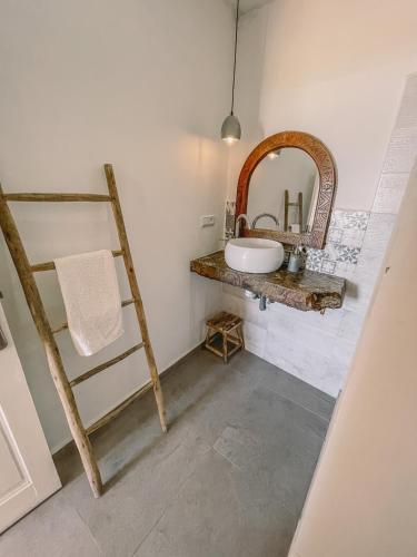 a bathroom with a sink and a mirror at Blue Waves Surf House - Anza I in Agadir