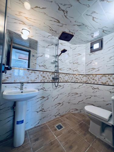 a bathroom with a sink and a toilet at Merzouga Desert Apartment in Merzouga