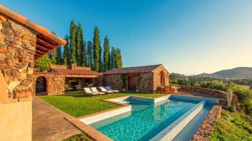 a villa with a swimming pool and a house at Casa Mori House in Stellenbosch