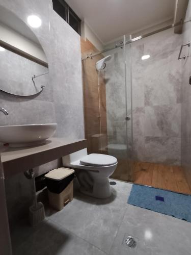 a bathroom with a sink and a toilet and a shower at Casa Sol in Tingo María