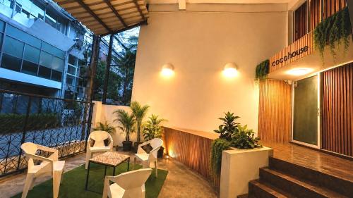 a lobby with chairs and tables and a building at Cocohouse Sukhumvit 1 in Makkasan