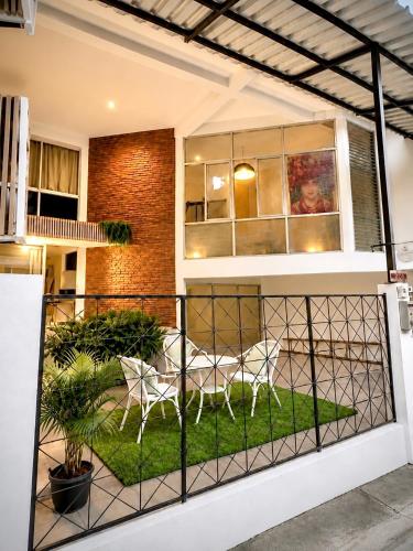 a balcony with a table and chairs on it at Cocohouse Sukhumvit 1 in Makkasan