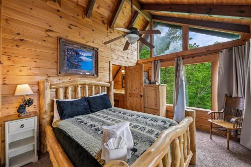 a bedroom with a bed in a log cabin at Mountain Magic #73 by Venture Smoky Mountains in Sevierville