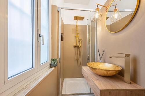 a bathroom with a wooden bowl sink and a mirror at MInerva Pantheon Suites in Rome