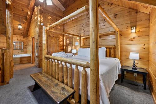 a bedroom with a bed in a log cabin at Once Upon a Time by Venture Smoky Mountains in Sevierville