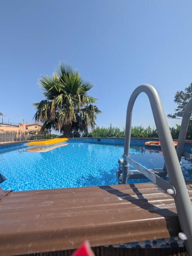 a swimming pool with a slide in a resort at Casa Malù in SantʼAlfio