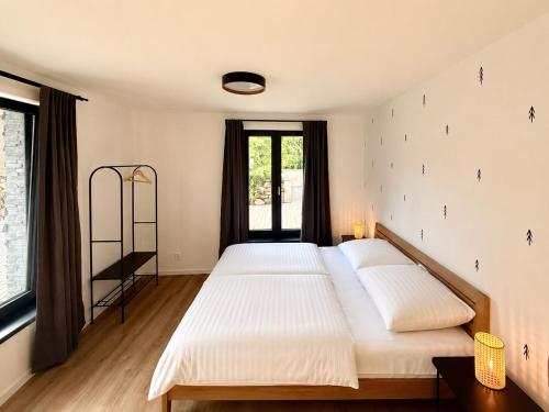 a bedroom with two beds and a window at Apartmány Perninský Dvůr in Pernink