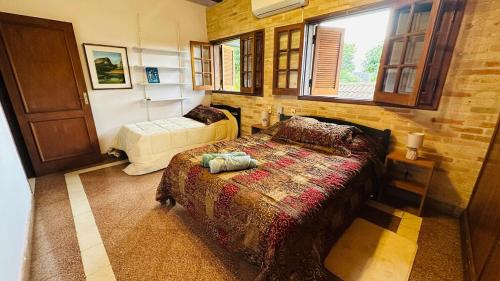 a bedroom with two beds and a window at Fina residencia con chimenea en Lambaré in Asunción