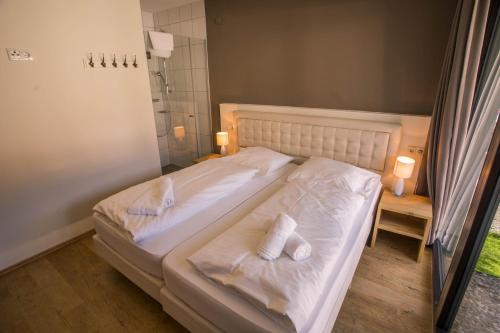 a bedroom with a bed with two towels on it at Appart Gastauer in Sankt Gallenkirch