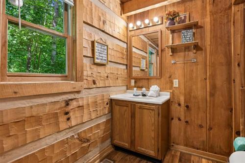 a bathroom with a sink and a mirror at Sequoyah by Venture Smoky Mountains in Cartertown