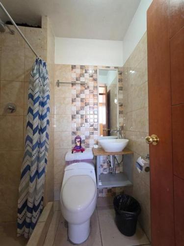 a bathroom with a toilet and a sink at Darios Hotel in Cusco