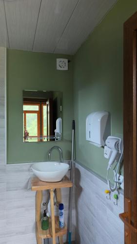 a bathroom with a white sink and a mirror at IparAlto in Mestia